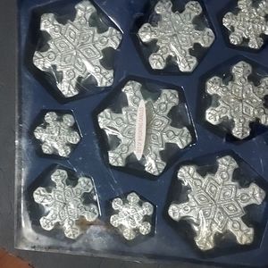 9 pc.Set GlitterSilverSnowflakes Floating Candles wrapped separately in plastic.